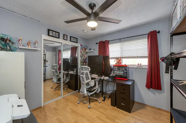a view of a workspace with furniture and a window