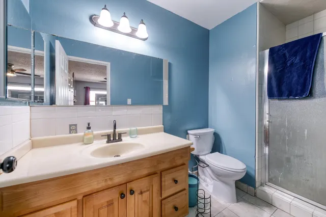 a bathroom with a sink vanity mirror and toilet