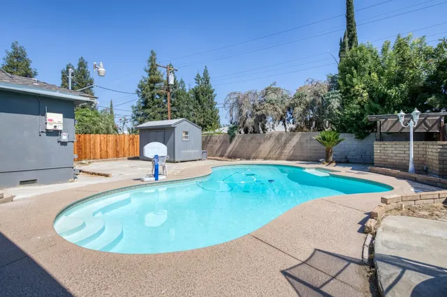 a view of a swimming pool with a patio