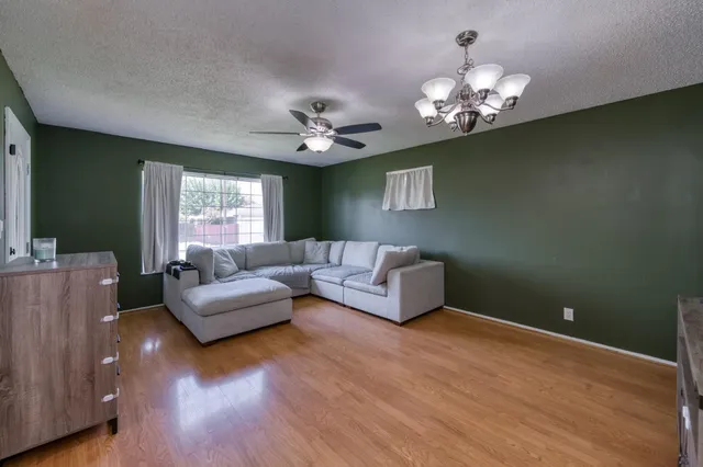 a living room with furniture and a chandelier
