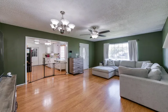 a living room with furniture and wooden floor