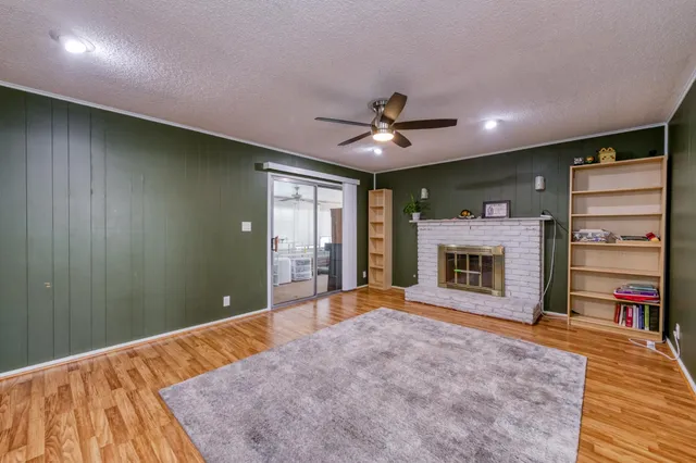 a bed room with a fireplace and a television