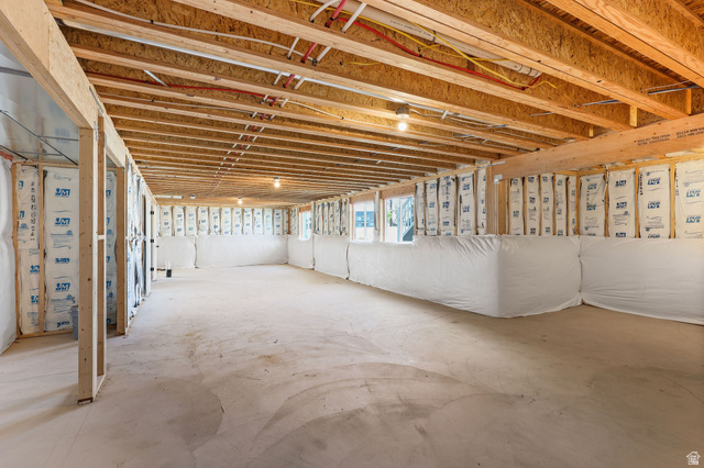 1144 South 4475 West West Point, UT 84015 - Photo 27 of 30 Unfinished basement space featuring exposed wood joists and subflooring, framed walls with insulation, concrete flooring, and multiple light fixtures