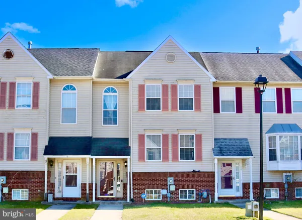 a front view of residential houses with yard