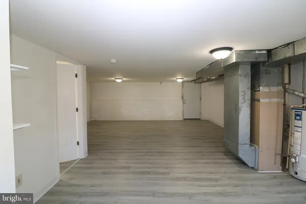 an empty room with wooden floor and a window