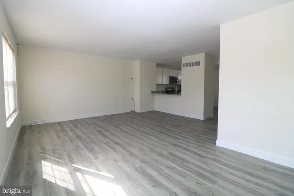 a view of a kitchen with wooden floor