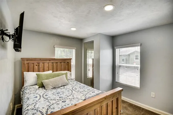 a bedroom with a large bed and a window