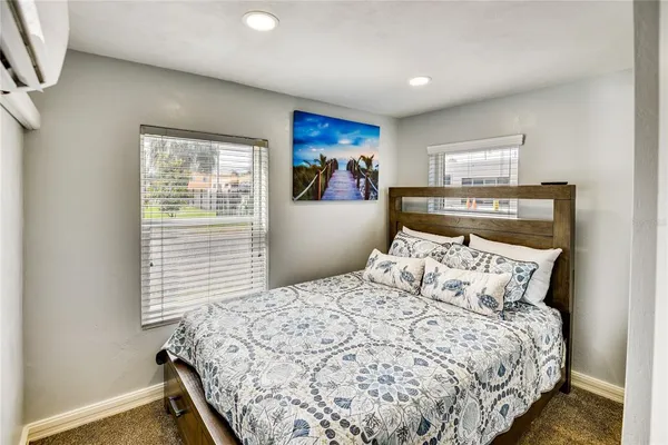 a bed sitting in a bedroom next to a window