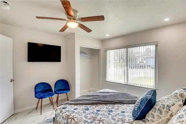 a bedroom with a bed a dresser and a window