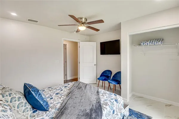a bedroom with a bed and a flat screen tv