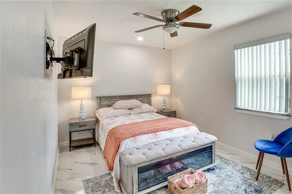 a kitchen with a refrigerator and white cabinets