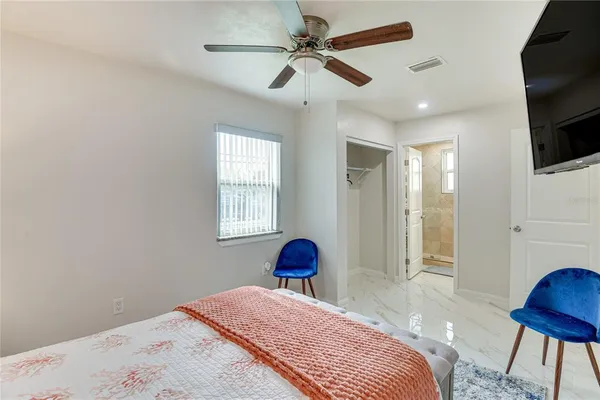 a view of an empty room and a bathroom with a sink
