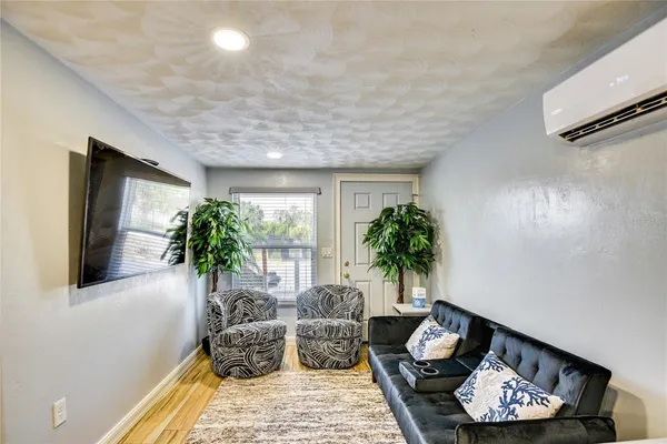 a living room with furniture and a potted plant