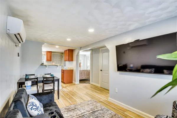 a living room with furniture and a wooden floor