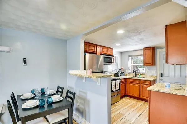 a kitchen with stainless steel appliances kitchen island granite countertop a sink and cabinets