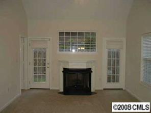 445 Robin Reed Court Pineville, NC 28134 - Photo 3 of 8 a living room with a fireplace and a window