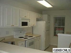 445 Robin Reed Court Pineville, NC 28134 - Photo 4 of 8 a kitchen with a sink a stove and refrigerator