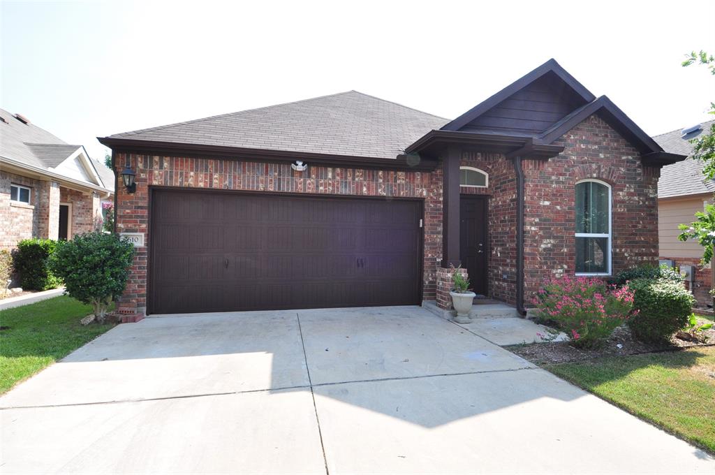 3451 Mayfield Ranch Boulevard, Unit 610 Round Rock, TX 78681 - Photo 1 of 19 View of front of home featuring driveway, an attached garage, and brick siding