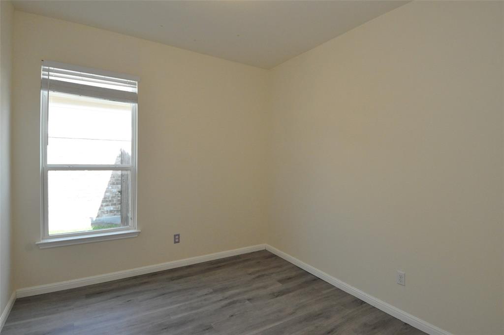 3451 Mayfield Ranch Boulevard, Unit 610 Round Rock, TX 78681 - Photo 15 of 19 Unfurnished room featuring baseboards and dark wood-type flooring