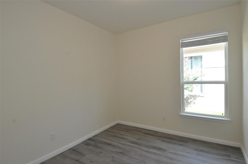 3451 Mayfield Ranch Boulevard, Unit 610 Round Rock, TX 78681 - Photo 16 of 19 Empty room with baseboards and dark wood-style flooring