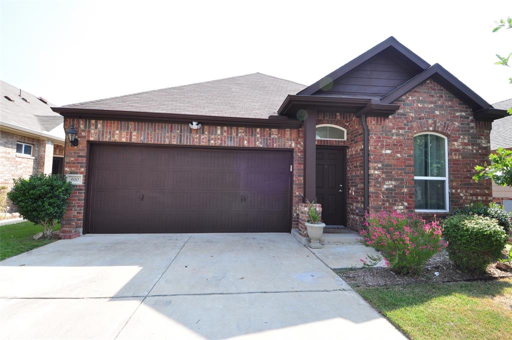 3451 Mayfield Ranch Boulevard, Unit 610 Round Rock, TX 78681 - Photo 2 of 19 View of front of house with concrete driveway, an attached garage, brick siding, and roof with shingles