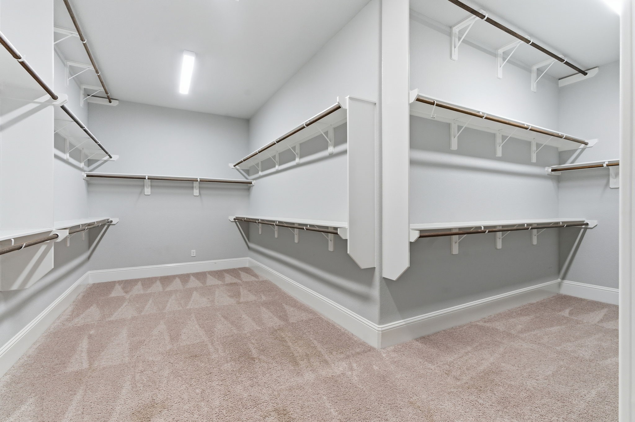 2208 Salt Grass Trail Conroe, TX 77384 - Photo 22 of 34 This particular primary suite walk-in closet is actually large enough for his and hers clothing, shoes, purses and whatever else you might wish to store here!