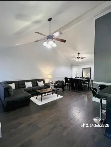 a living room with furniture and a chandelier
