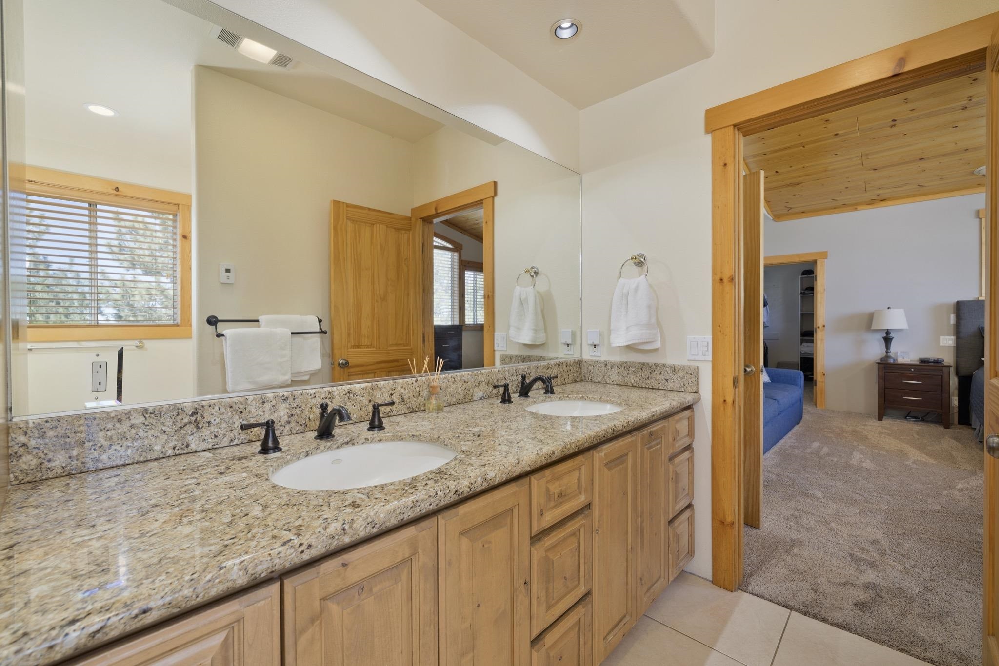 23 Trails End Road Mammoth Lakes, CA 93546 - Photo 12 of 50 a bathroom with a granite countertop sink and a mirror