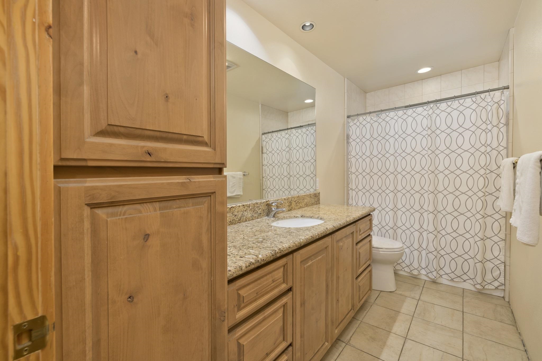 23 Trails End Road Mammoth Lakes, CA 93546 - Photo 22 of 50 a bathroom with a granite countertop sink and a mirror