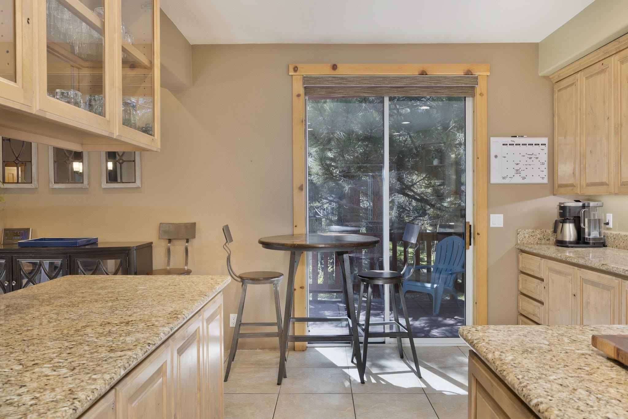 23 Trails End Road Mammoth Lakes, CA 93546 - Photo 34 of 50 a kitchen with a table chairs refrigerator and cabinets