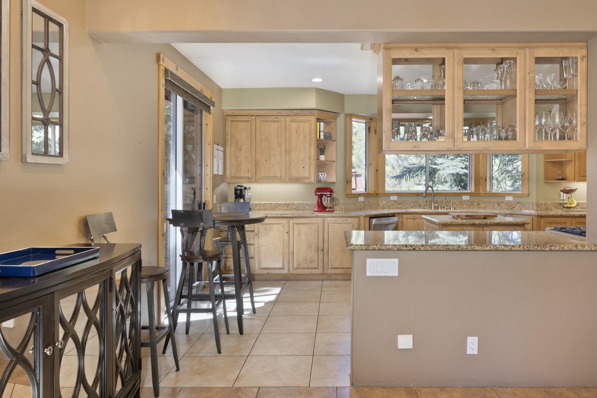 23 Trails End Road Mammoth Lakes, CA 93546 - Photo 4 of 50 a kitchen with kitchen island granite countertop a table and chairs in it