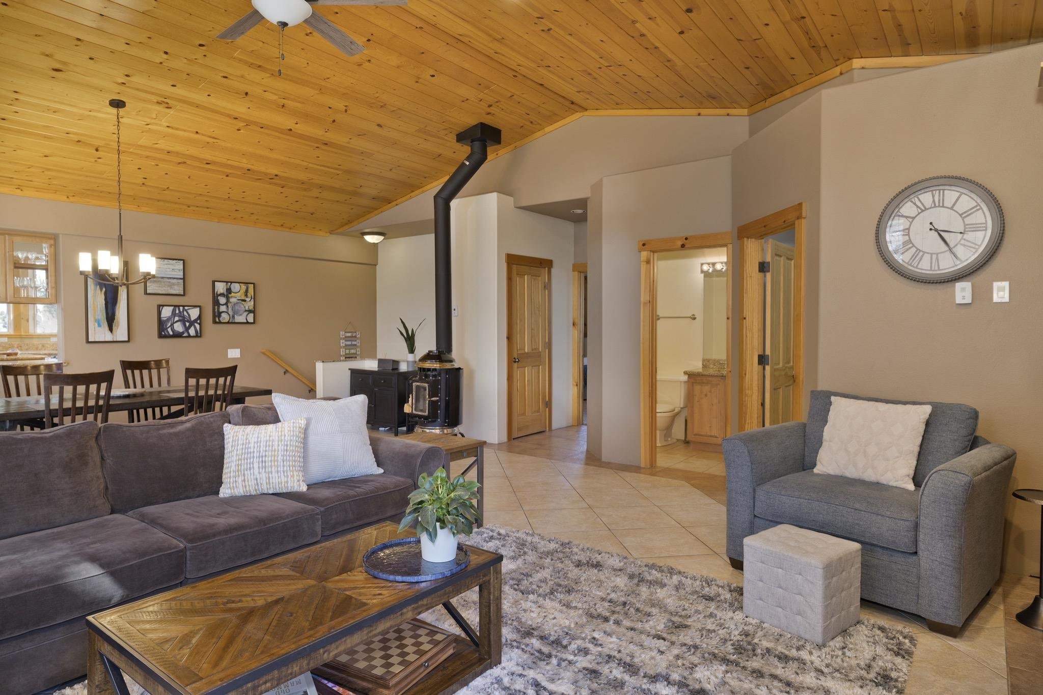 23 Trails End Road Mammoth Lakes, CA 93546 - Photo 41 of 50 a living room with furniture a clock on wall and a table