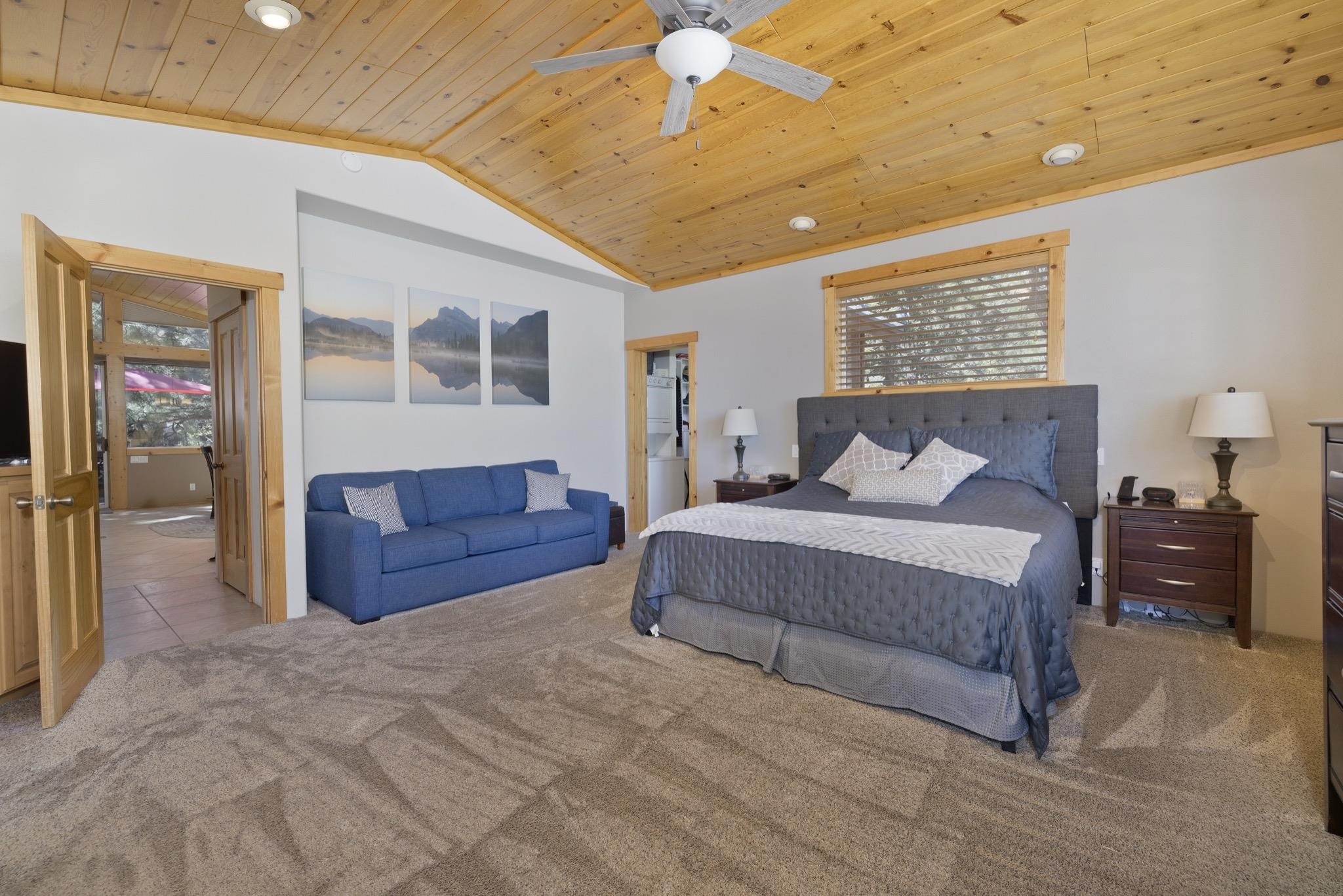 23 Trails End Road Mammoth Lakes, CA 93546 - Photo 9 of 50 a bedroom with a large bed and a chandelier