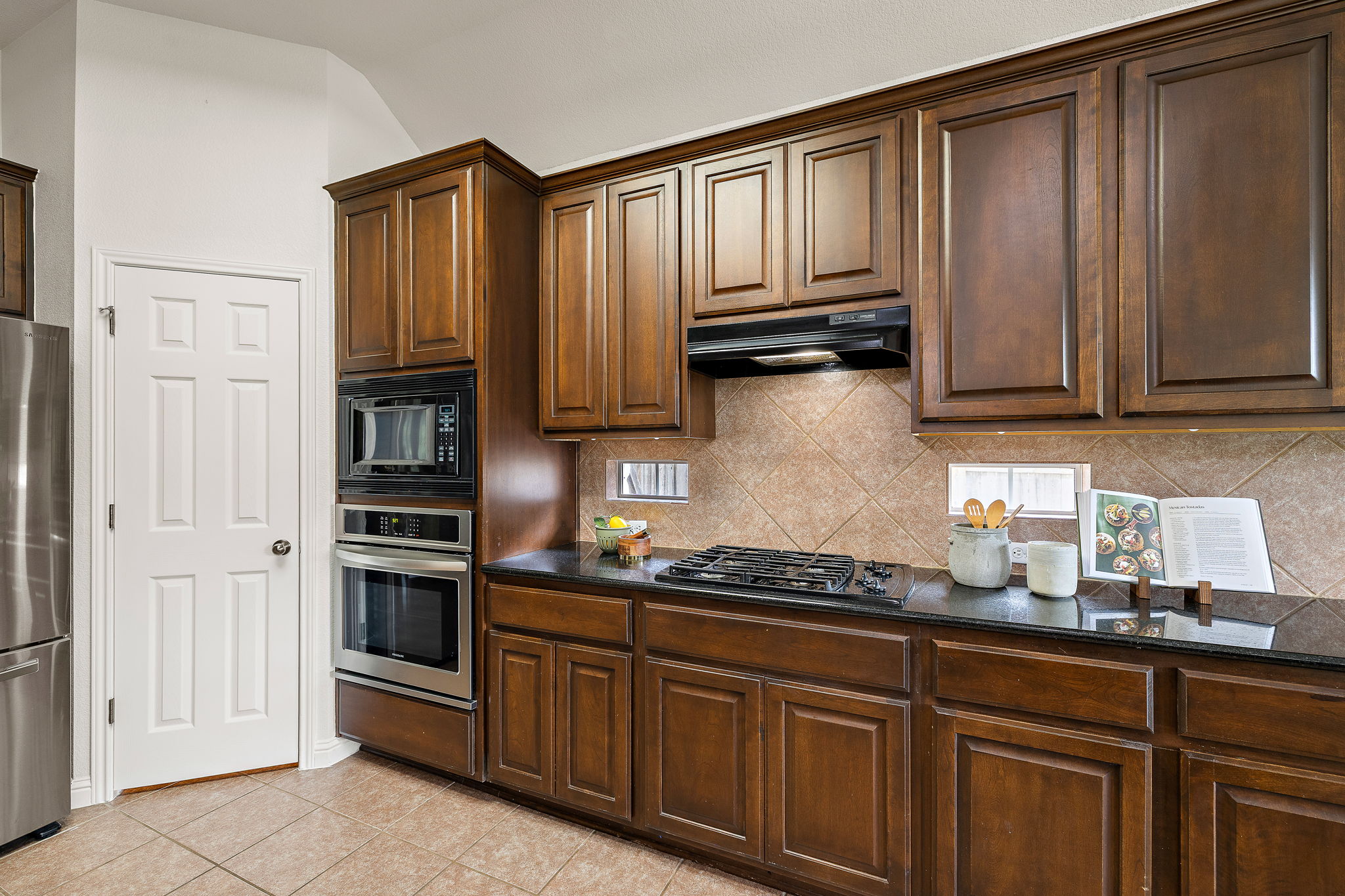 1115 Canyon Maple Road Pflugerville, TX 78660 - Photo 13 of 34 Built in gas range, hood, oven, and microwave