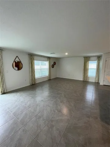 a view of a livingroom with wooden floor and a window