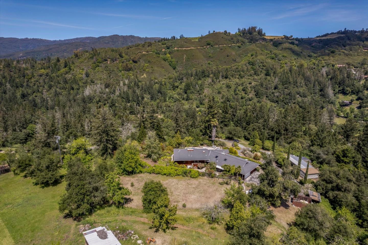 25149 Radonich Road Los Gatos, CA 95033 - Photo 40 of 47 a view of a lush green hillside and a houses