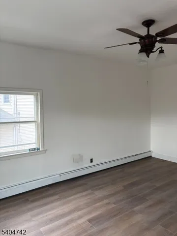 a view of a room with wooden floor and window