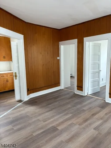 an empty room with wooden floor and closet