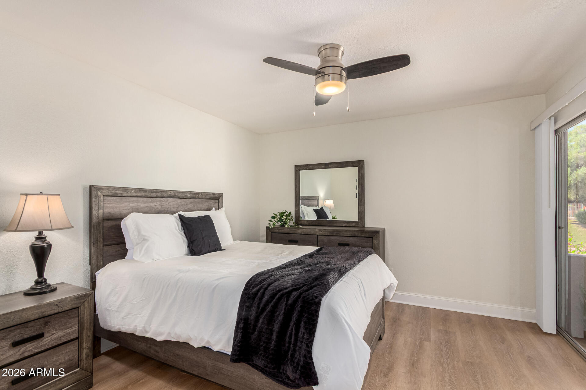 5877 North Granite Reef Road, Unit 1133 Scottsdale, AZ 85250 - Photo 18 of 33 a bedroom with a bed and a night stand