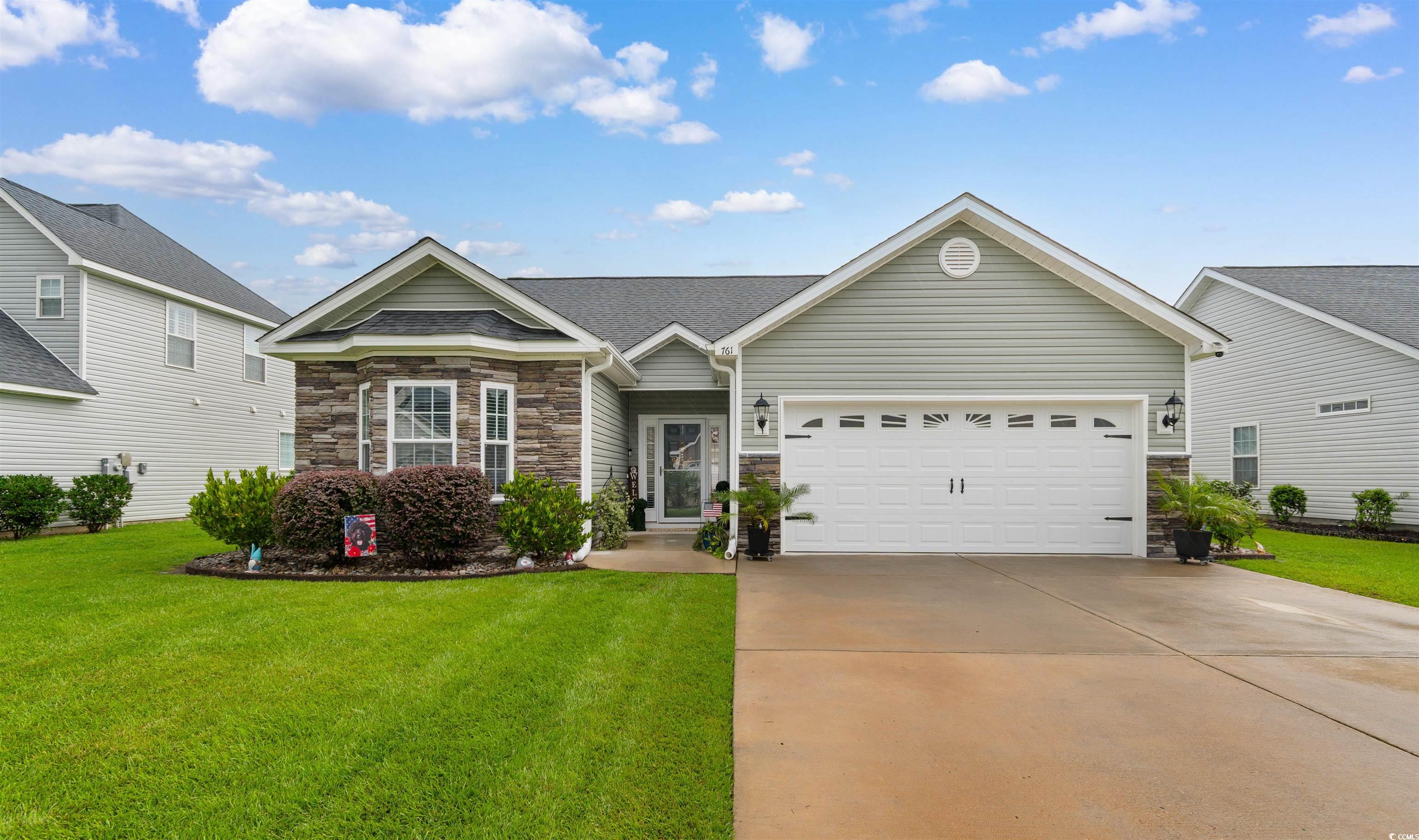 761 Hobonny Loop Longs, SC 29568 - Photo 1 of 31 View of front of property with stone siding, a front lawn, an attached garage, and concrete driveway