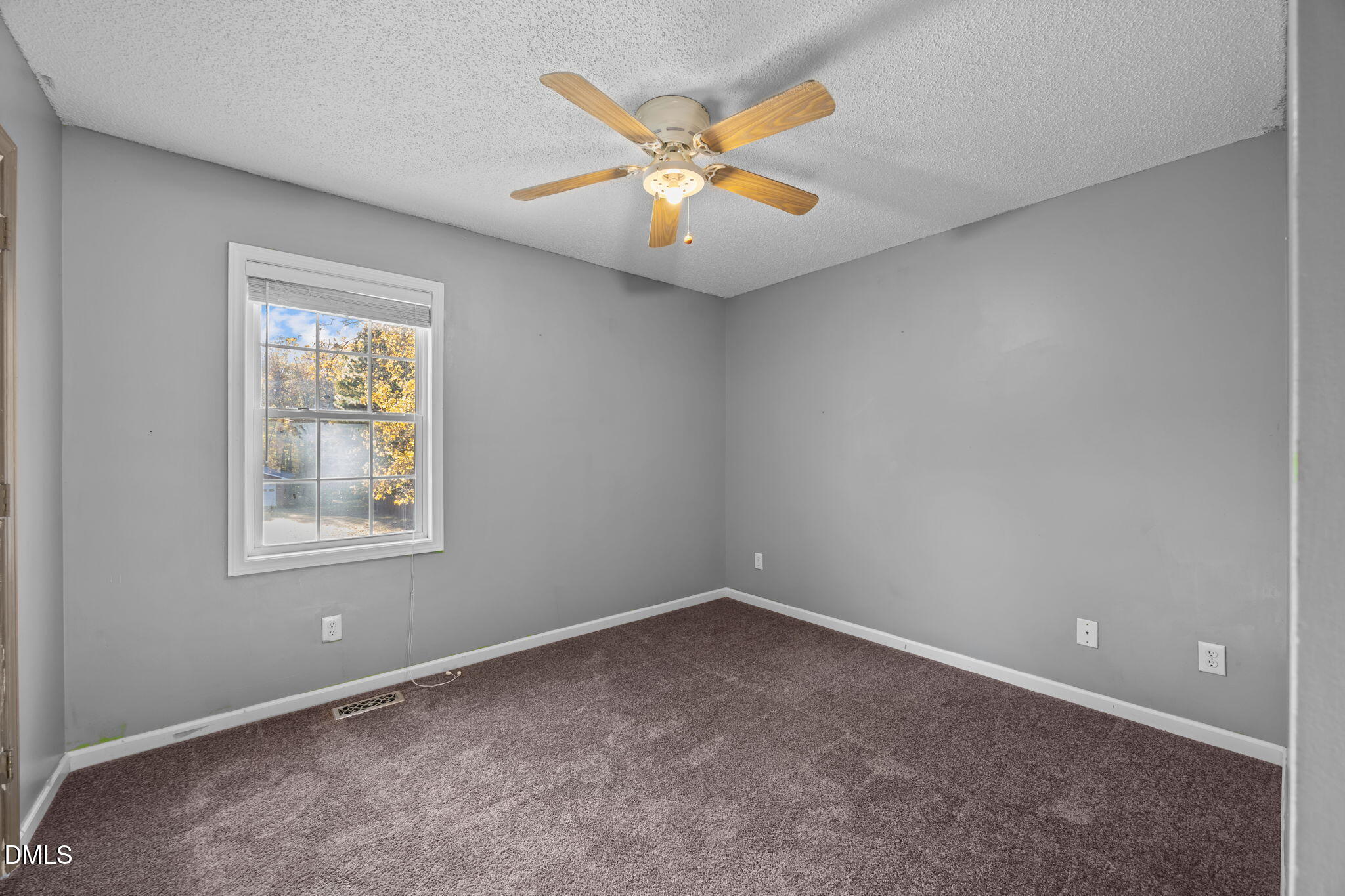 2267 South Jim Minor Road Haw River, NC 27258 - Photo 18 of 36 an empty room with a ceiling fan and window