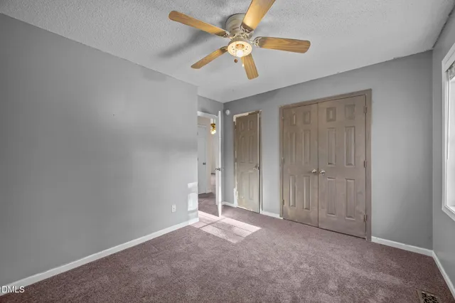 a bathroom with a toilet sink vanity and mirror