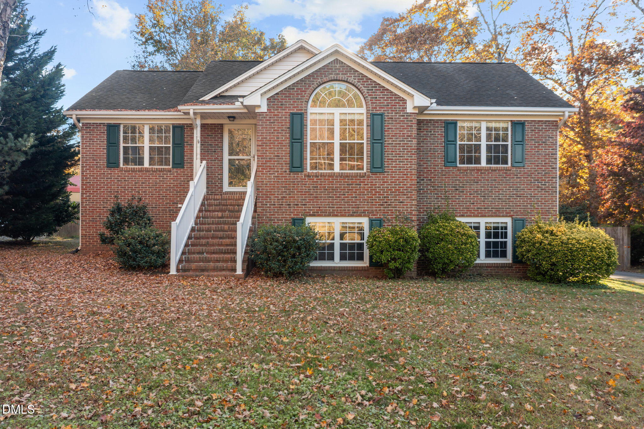 2267 South Jim Minor Road Haw River, NC 27258 - Photo 2 of 36 a view of a brick house with many windows next to a yard