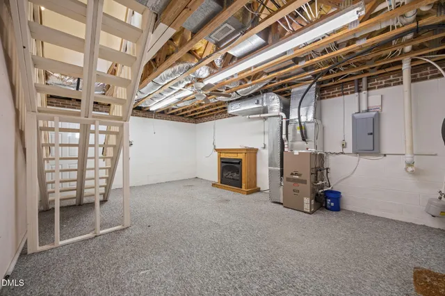 a view of a house with a yard and large tree
