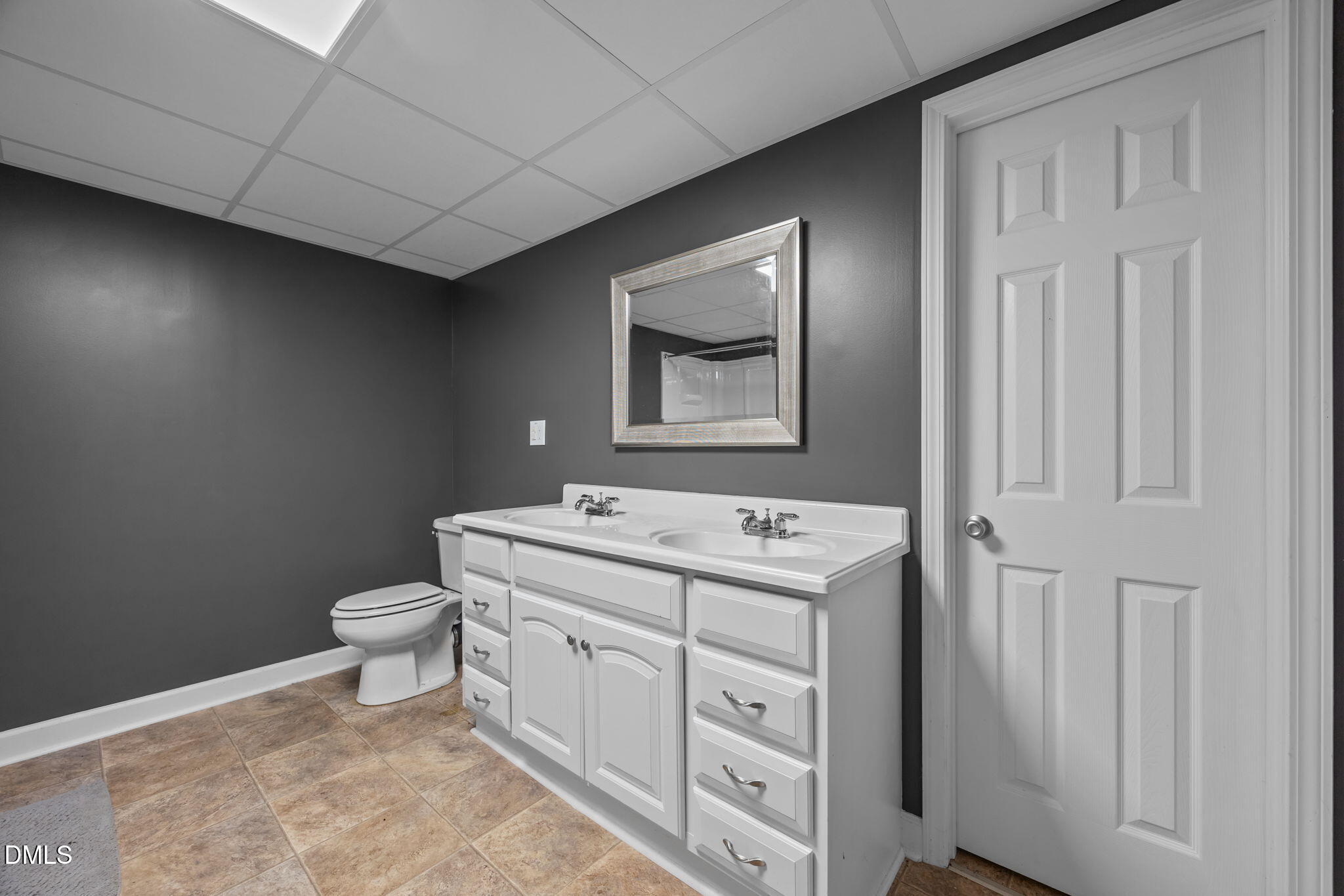 2267 South Jim Minor Road Haw River, NC 27258 - Photo 24 of 36 a bathroom with a toilet sink vanity and mirror