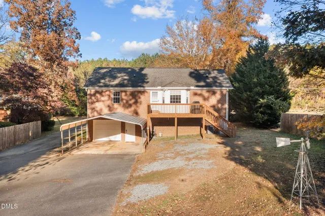 an empty room with a ceiling fan and window