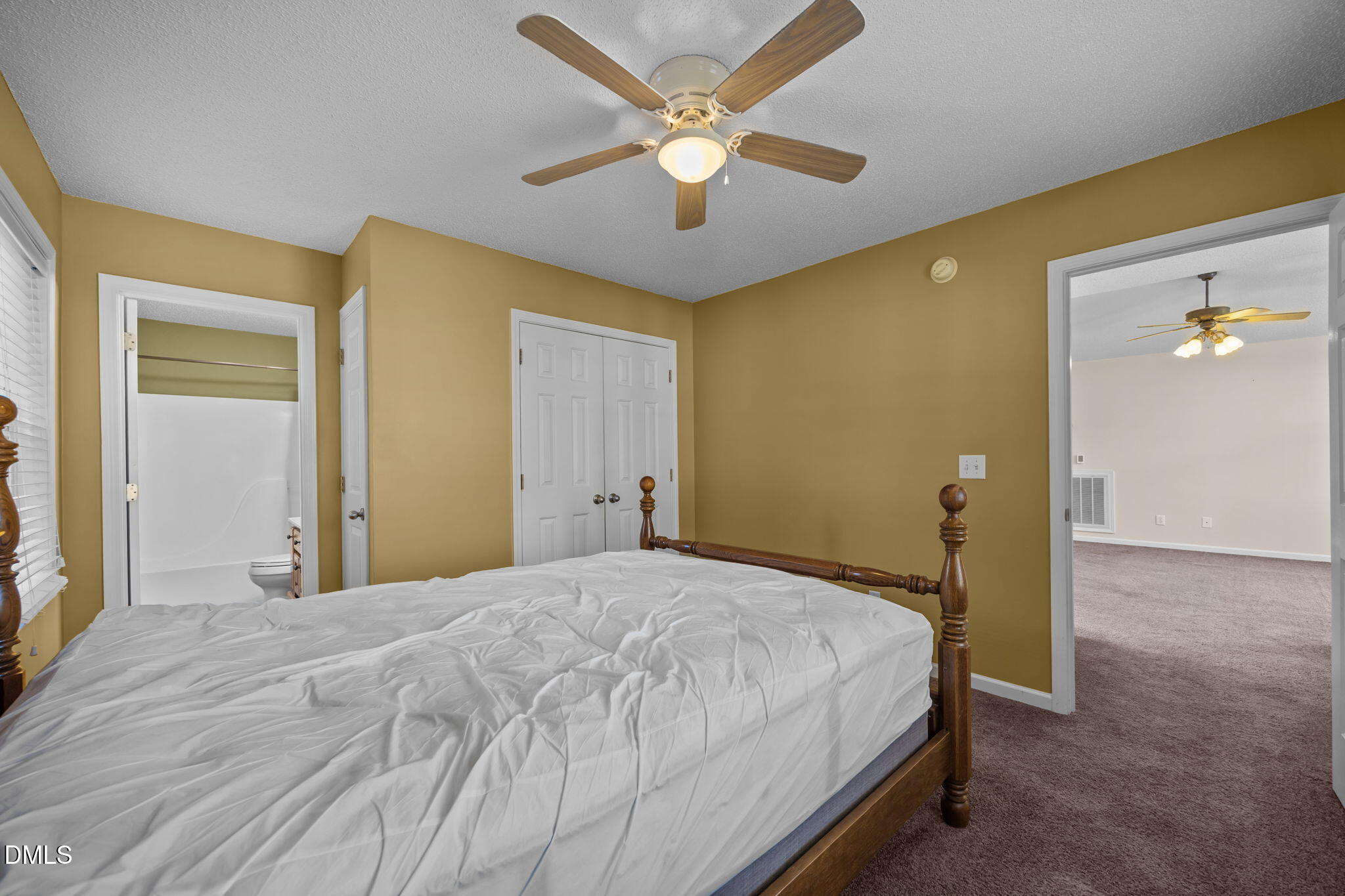 2267 South Jim Minor Road Haw River, NC 27258 - Photo 10 of 36 a bedroom with a bed and a chandelier