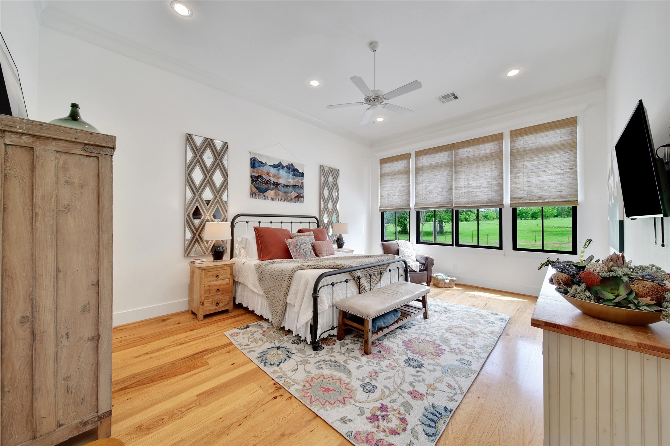 18875 Rabon Chapel Road Montgomery, TX 77316 - Photo 14 of 45 a spacious bedroom with a bed and a flat screen tv