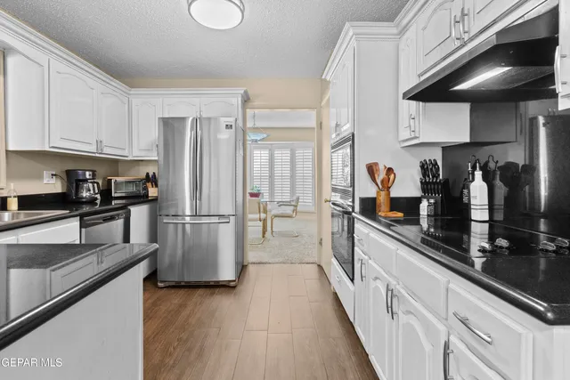 a kitchen with a sink cabinets and window