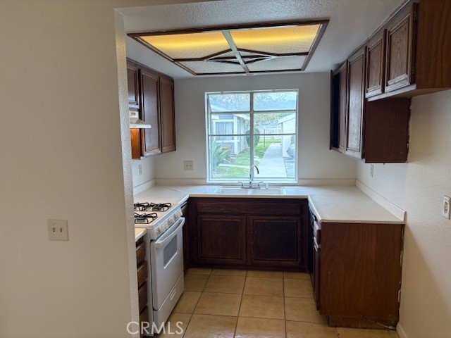 25989 Baylor Way Hemet, CA 92544 - Photo 5 of 15 a kitchen with stainless steel appliances granite countertop a stove a sink and a microwave